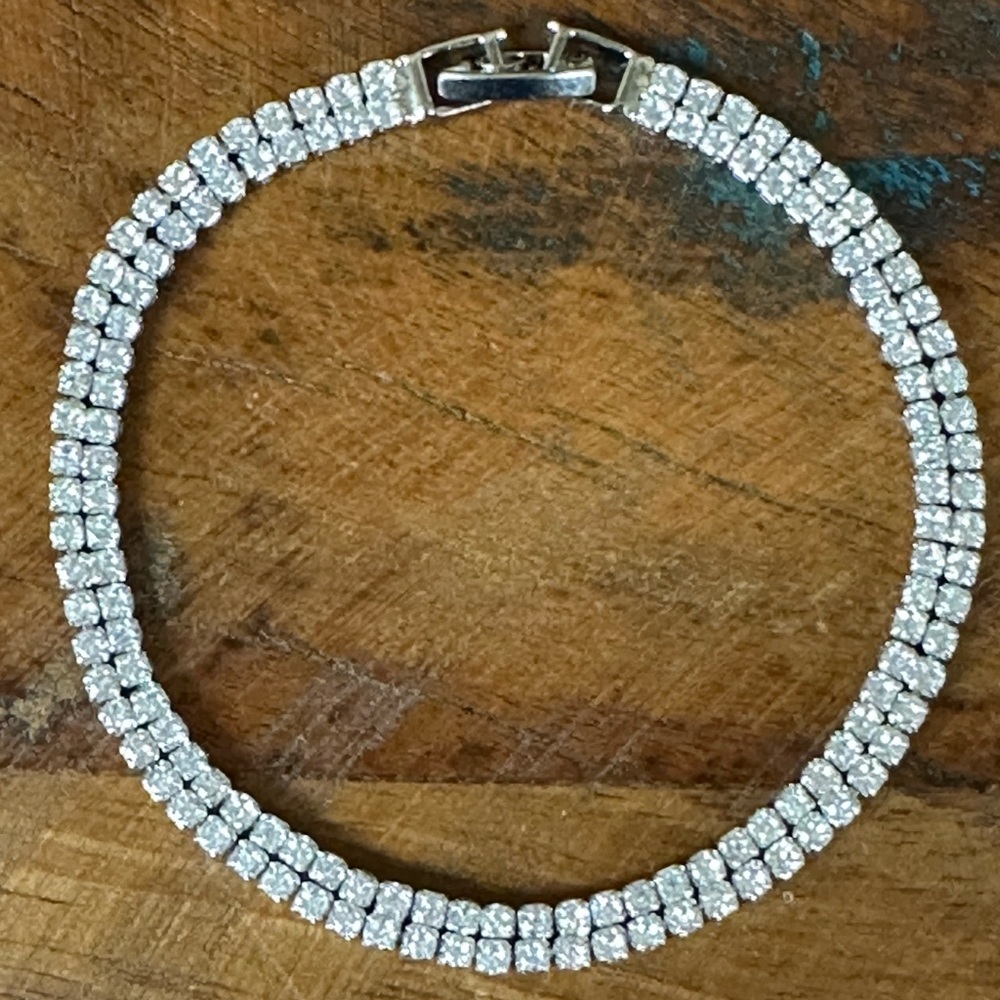 Marquise cut diamonds set in white gold plated line bracelet.